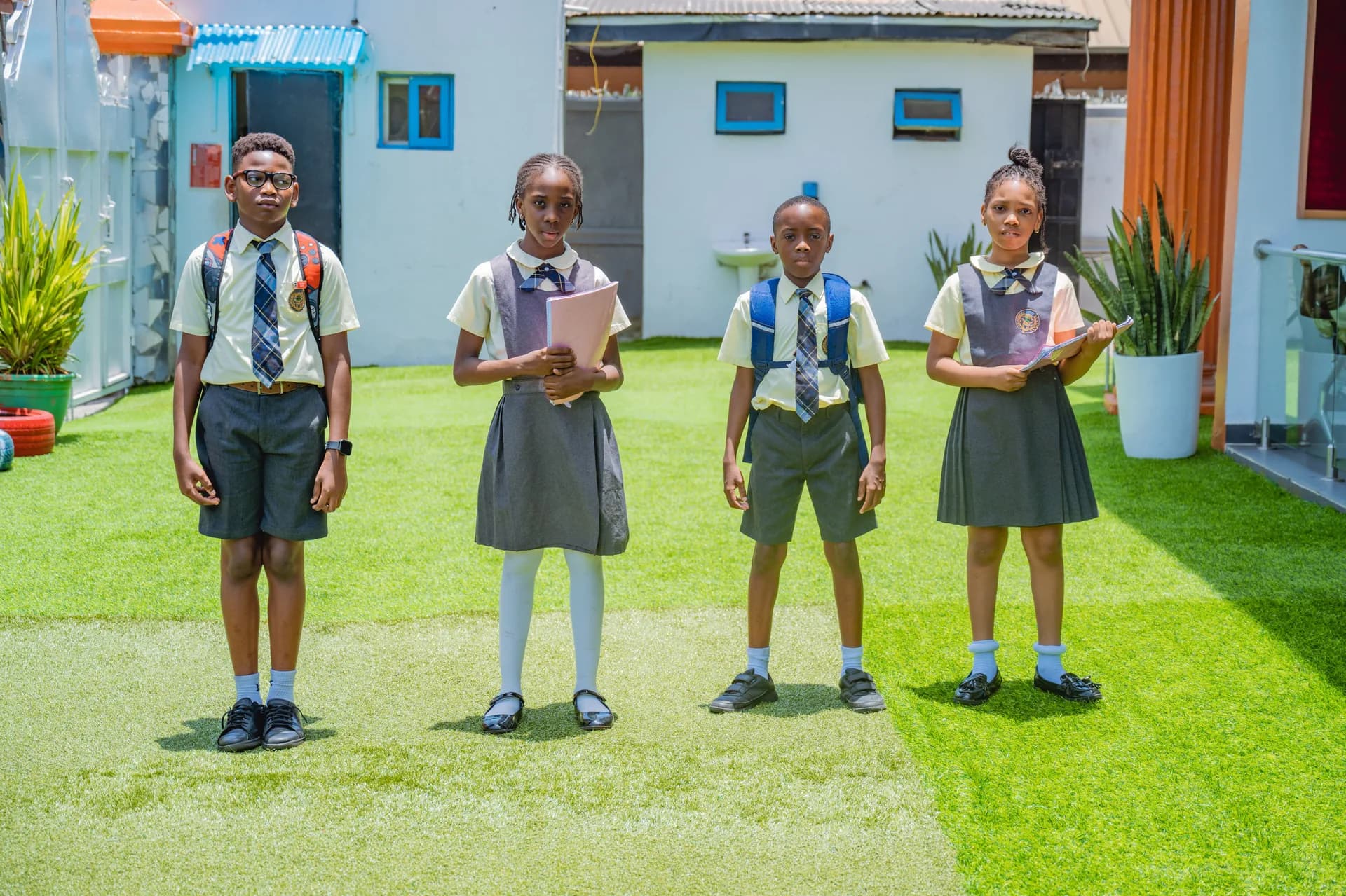 Tenderville students in school uniform on the school grounds