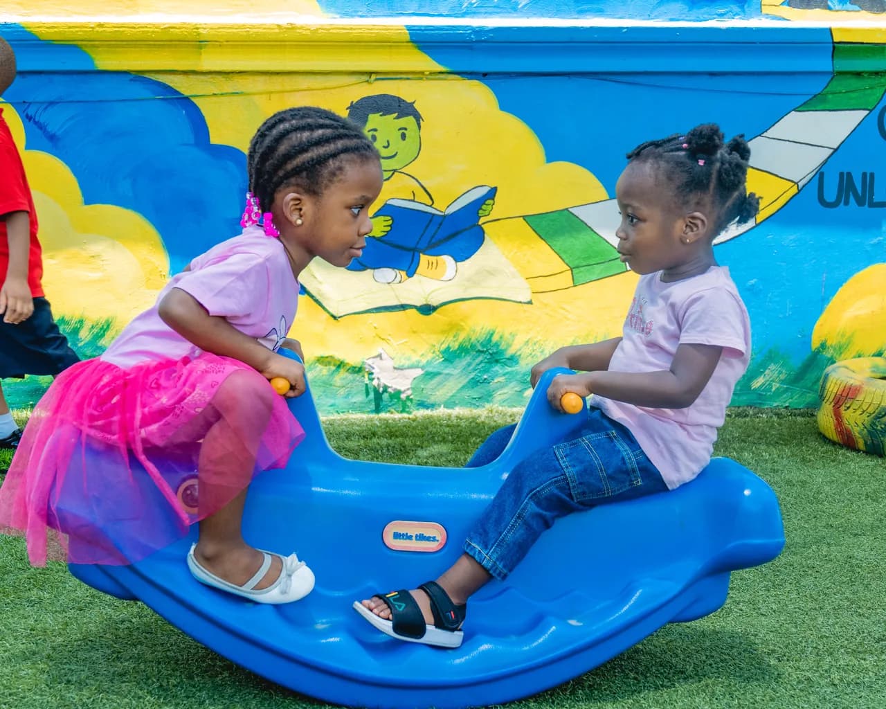 Two young Tenderville students playing together in the playground