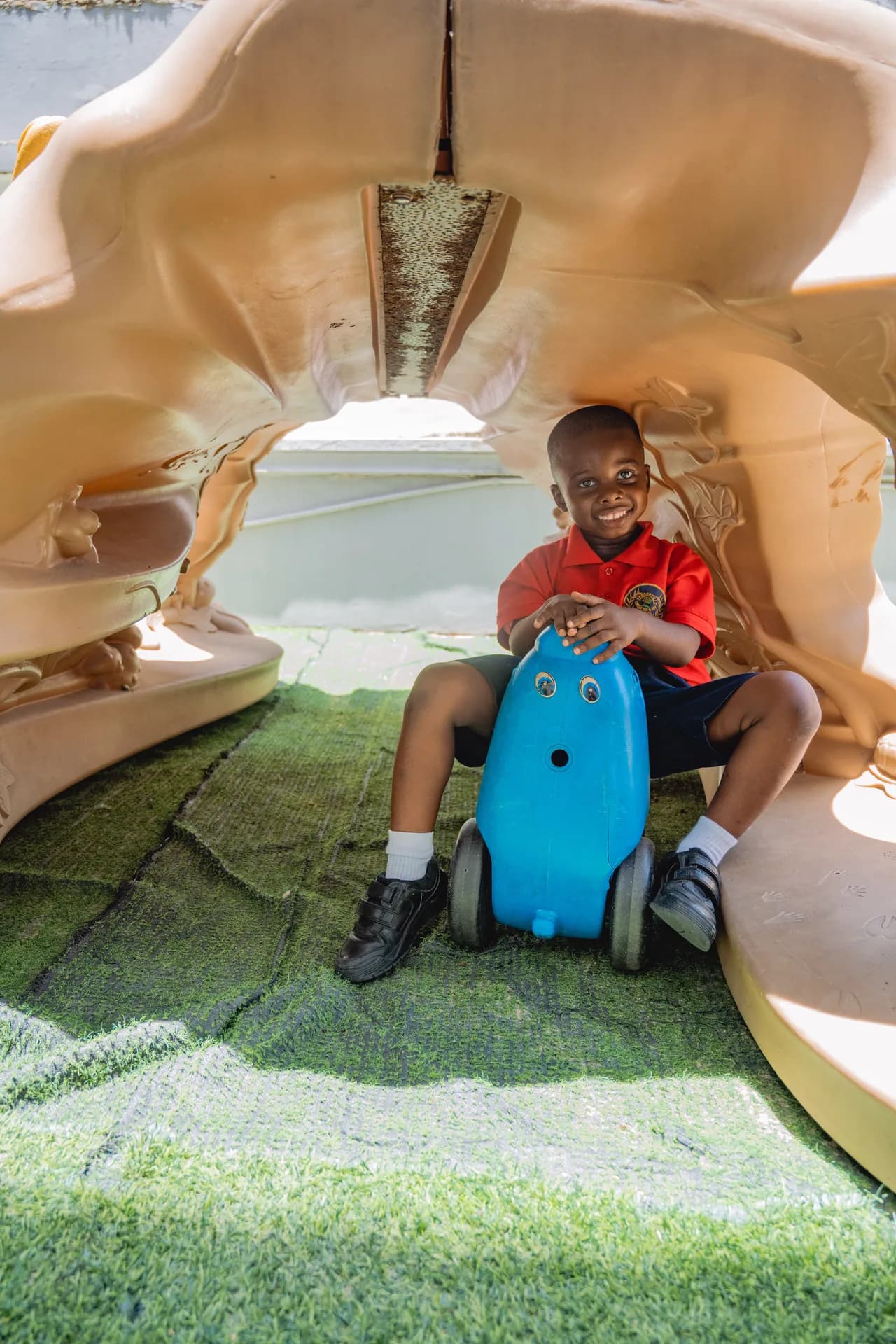 Smiling Tenderville toddler in a safe play area